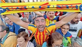  ??  ?? A man displays a scarf featuring an Estelada (Catalan separatist flag) design, as he reacts at Sant Jaume Square after the Catalan regional parliament declares independen­ce from Spain in Barcelona, Spain October 27, 2017. REUTERS