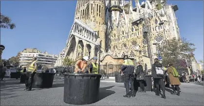  ?? JORDI COTRINA ?? Operaris municipals col·loquen els testos gegants al carrer de Sardenya, davant la Sagrada Família, ahir.