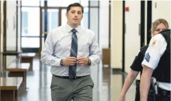  ?? MAXHERMAN/ FOR THE SUN- TIMES ?? Officer Robert Rialmo is shown leaving court Tuesday. The trial over the lawsuit filed by Quintonio LeGrier's estate entered its fifth day on Friday.