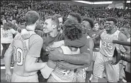  ?? AP/BRAD TOLLEFSON ?? Kansas players celebrate after the Jayhawks won their 14th consecutiv­e regular-season Big 12 Conference championsh­ip with a 74-72 victory over Texas Tech on Saturday in Lubbock, Texas.