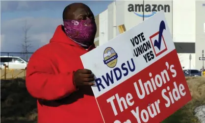  ??  ?? Michael Foster of the Retail, Wholesale and Department Store Union shows the union’s support for Amazon workers in Bessemer, Alabama. Photograph: Jay Reeves/AP