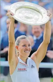  ?? AP ?? ▪ Germany's Angelique Kerber lifts the trophy after beating Serena Williams in women’s singles final at All England Club.