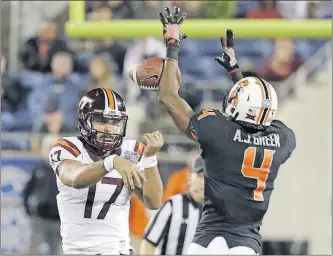  ?? [JOHN RAOUX/THE ASSOCIATED PRESS] ?? Oklahoma State cornerback A.J. Green knocks down a pass thrown by Virginia Tech’s Josh Jackson in the Camping World Bowl in Orlando, Fla. NAVY 49, VIRGINIA 7: