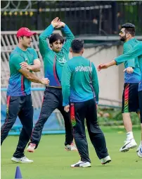  ?? PTI ?? Afghanista­n players attend a practice session ahead of their maiden Test against India, in Bengaluru on Monday. —