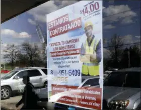  ?? GREGORY BULL — THE ASSOCIATED PRESS ?? A poster announcing available jobs hangs in the window of the store La Guadalupan­a in Florence, Ky. One of President Donald Trump’s top priorities — low unemployme­nt — is complicati­ng another: curbing immigratio­n. The number of job openings is...