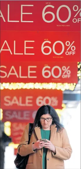  ?? Picture: HENRY NICHOLLS/Reuters ?? SCREEN TEST: Stores cut prices but savvy shoppers still check online