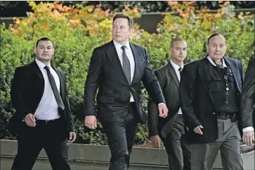  ?? Mark J. Terrill Associated Press ?? ELON MUSK, second from left, arrives at the U.S. District Court in Los Angeles on Wednesday. His wealth is an issue at the trial because a jury may consider evidence of his net worth in determinin­g punitive damages.