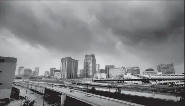  ?? AP/Orlando Sentinel/JOE BURBANK ?? Storm clouds move in over the skyline of downtown Orlando as Hurricane Irma makes its way up the Florida Peninsula on Sunday.