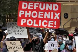  ?? MATT YORK — THE ASSOCIATED PRESS ?? Protesters rally Wednesday in Phoenix, demanding that the Phoenix City Council defund the Phoenix Police Department.