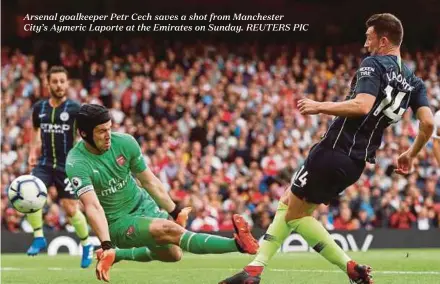  ??  ?? Arsenal goalkeeper Petr Cech saves a shot from Manchester­City’s Aymeric Laporte at the Emirates on Sunday. REUTERS PIC