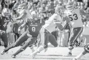  ?? SEAN RAYFORD/ASSOCIATED PRESS ?? UF QB Malike Zaire tries to elude the rush of South Carolina’s D.J. Wonnum during Saturday’s SEC meeting.