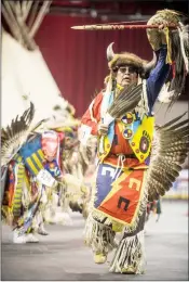  ??  ?? Dancers, above and at right, participat­e in the Grand Entry during the opening ceremonies of the 18th Annual Peace Powwow at the Enmax Centre on Saturday.