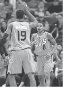  ?? MICHAEL CHOW/AZCENTRAL SPORTS ?? Suns guard Tyler Ulis (8) gets a high-five from guard Leandro Barbosa after drawing a foul against the Celtics on Sunday at Talking Stick Resort Arena in Phoenix.