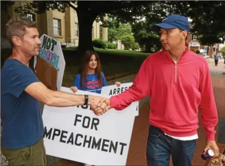  ?? PETE BANNAN — DIGITAL FIRST MEDIA ?? Protester Jack Guida shakes hands with Congressma­n Ryan Costello, R-6, Friday outside the Congressma­n’s West Chester office.