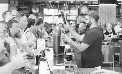  ?? KEVIN RICHARDSON/BALTIMORE SUN PHOTOS ?? The Guinness Open Gate Brewery & Barrel House opens its gates to the public. More than a thousand patrons visited in the first hour after the opening on Friday.