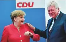  ?? AFP ?? Angela Merkel talks with Hesse’s State Premier and Deputy Chairman of the Christian Democratic Union Volker Bouffier prior to a party leadership meeting yesterday.