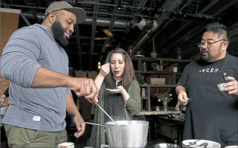  ?? Antonella Crescimben­i/Post-Gazette ?? Courtney Scott, center, samples the Thai green curry she and her husband Derek Scott, left, both from Brookline, made while Piyo Boonyarat, right, watches during a cooking class in February at Thai Me Up restaurant on the South Side.