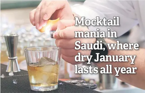  ?? — AFP photos ?? Lebanese bartender Hadi Ghassan prepares a drink behind the counter at ‘Meraki Riyadh’, a pop-up bar offering non-alcoholic bellinis and spritzes, served in chilled cocktail glasses, in Riyadh.