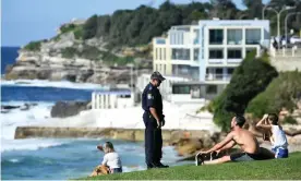  ??  ?? Police were out over the Easter long weekend enforcing coronaviru­s social distancing laws, including interrupti­ng a funeral in Victoria and moving on people at Bondi. Photograph: Joel Carrett/EPA