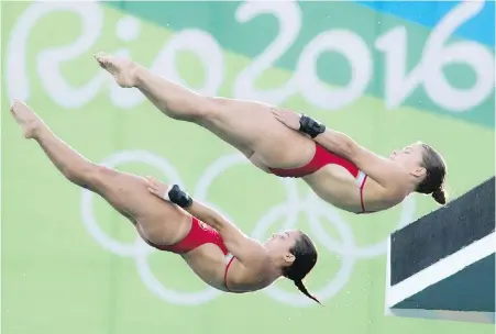  ??  ?? Canada’s Meaghan Benfeito, left, and Roseline Filion perform a dive on their way to a bronze-medal win in women’s synchroniz­ed 10-metre platform diving at the Summer Olympics in Rio de Janeiro on Tuesday.