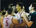  ?? TONY AVELAR — THE ASSOCIATED PRESS ?? Stanford forward Oscar da Silva, center, celebrates with teammates after scoring in overtime for a victory against UCLA in Santa Cruz on Saturday.