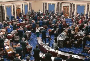  ?? Senate Television via Associated Press ?? Senators and staff give a standing ovation to Capitol Police officer Eugene Goodman before voting to award him the Congressio­nal Gold Medal for his actions during the Jan. 6 riot.