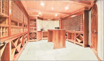  ??  ?? Whether privately enjoyed or shared with friends and family, the wine cellar and tasting room is one of several in-home amenities.