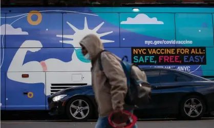  ?? Photograph: Xinhua/REX/Shuttersto­ck ?? A person walks in front of a Covid vaccine site in Brooklyn, New York.