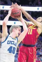  ??  ?? UCLA SEVEN-FOOTER Thomas Welsh takes a rebound away from USC guard Jordan McLaughlin during the first half.