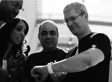  ?? Handout ?? Apple chief executive Tim Cook displays his personal Apple Watch to customers in Palo Alto, Calif. Cook says “demand is greater than the supply” right now for the watch.