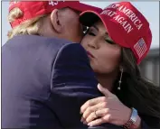  ?? JEFF DEAN — THE ASSOCIATED PRESS ?? Donald Trump embraces South Dakota Gov. Kristi Noem at Saturday's rally in Vandalia, Ohio.