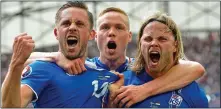  ??  ?? JOY: Iceland players erupt in celebratio­n after taking the lead against Hungary