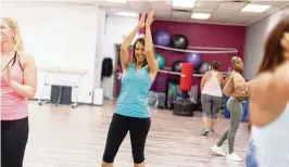  ?? ?? Fun and fitness blend seamlessly for a full-body workout in the Dayton Metro Library’s Zumba classes.