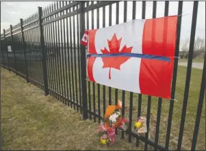  ?? The Assoicated Press ?? TRIBUTE: A tribute is displayed Monday, at the Royal Canadian Mounted Police headquarte­rs in Dartmouth, Nova Scotia, following a weekend shooting rampage by a gunman, disguised as a police officer, that killed multiple people including an RCMP constable.