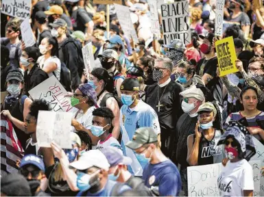  ?? Photos by Marie D. De Jesús / Staff photograph­er ?? A pair of faith leaders join thousands of protesters marching in honor of George Floyd downtown last week.