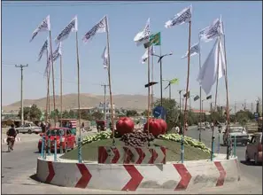  ?? (AP/Gulabuddin Amiri) ?? Taliban flags fly over a square Saturday in the Afghan city of Ghazni, southwest of Kabul.