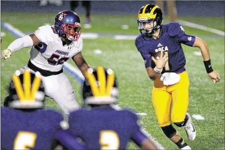  ?? RICHARD GRAULICH / THE PALM BEACH POST Special to the Post ?? Boca Raton quarterbac­k Micah Leon (right) attempts to move past Pahokee’s Brian Crawford during the first half.