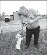  ?? NWA Democrat-Gazette/FLIP PUTTHOFF ?? Cody Wilson, an animal control officer, takes pooch Celena out for a walk Tuesday at the Centerton Animal Shelter.