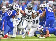  ?? ADRIAN KRAUS - THE ASSOCIATED PRESS ?? Philadelph­ia Eagles’ Miles Sanders (26), center, breaks through the Buffalo Bills defense to score a touchdown during the second half of an NFL football game, Sunday, Oct. 27, 2019, in Orchard Park, N.Y.