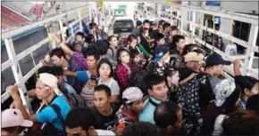  ?? YE AUNG THU/AFP ?? Migrant workers pass the Thai-Myanmar border in an official service truck as they leave Thailand from Mae Sot, in northern Thailand, on Friday.