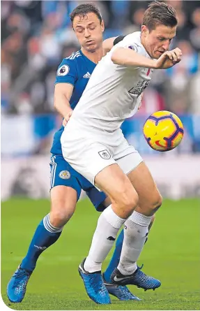  ??  ?? Leicester’s Jonny Evans and Burnley’s Chris Wood battle for the ball