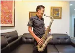  ??  ?? Taiwan musician and former political prisoner Chen Shen-ching plays the saxophone during an interview in New Taipei City.