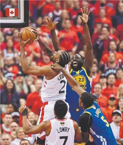  ?? Frank Gunn, The Canadian Press ?? Toronto Raptors forward Kawhi Leonard goes up for a basket under pressure from Golden State Warriors forward Draymond Green (23) and center Kevon Looney on Monday night in Game 5.