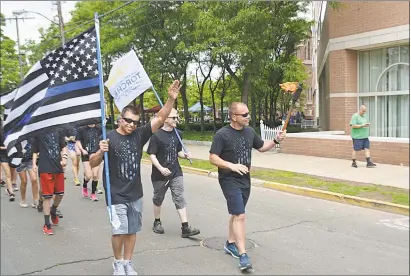  ?? Cassandra Day / Hearst Connecticu­t Media ?? More officers and civilians than ever took part in leg three of the three-day annual Law Enforcemen­t Torch Run for Special Olympics Connecticu­t, which began on Thursday in North Branford.