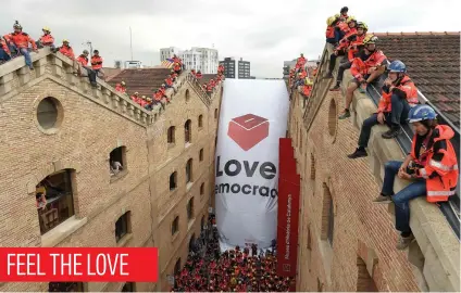  ?? Picture: AFP ?? Catalan firefighte­rs unfold a banner with a ballot box in front of the Museum of History of Catalonia in Barcelona yesterday. Prosecutor­s have ordered police to seal off polling stations until Sunday.