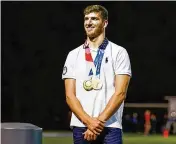  ?? NICK GRAHAM / STAFF ?? Trenton native and 2015 Edgewood High School graduate Zach Apple was honored at halftime of a Cougars’ football game in 2021. A two-time gold medal winner, Apple had the entranced to the high school named after him