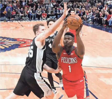  ?? DERICK E. HINGLE/USA TODAY SPORTS ?? Zion Williamson drives past Spurs center Jakob Poeltl during the fourth quarter Wednesday.