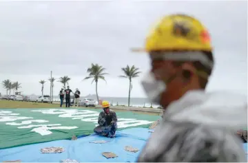  ??  ?? Environmen­tal activists attend a protest as Brazil’s government hold the pre-salt offshore oil auction in Rio de Janeiro.