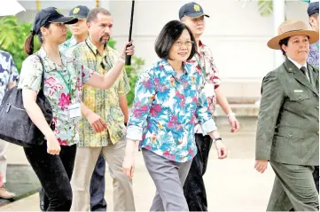  ??  ?? Tsai (centre), on transit enroute to Pacific island allies, visits the USS Arizona memorial at Pearl Harbor near Honolulu, Hawaii. — Reuters photo