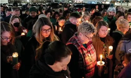  ?? News, Virginia. Photograph: Billy Schuerman/AP ?? Attendees hold a vigil for Abby Zwerner, the teacher shot by a six-year-old student at Richneck Elementary, on 9 January, in Newport